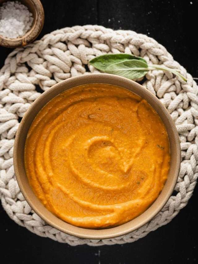 butternut sauce in a serving bowl, dish with salt, sage leaf