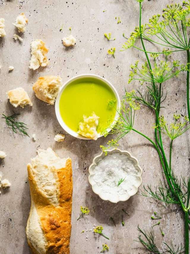 dish with dill oil, branches of fresh dill, bread crumbs, baguette, dish with salt