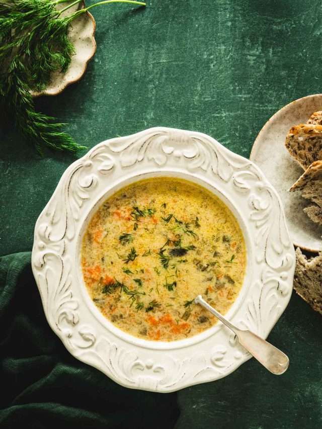 dill pickle soup in a serving bowl, green background