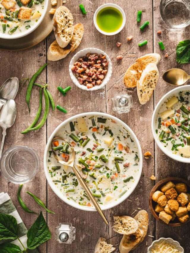 serving bowls with green bean soup, croutons, slices of bread