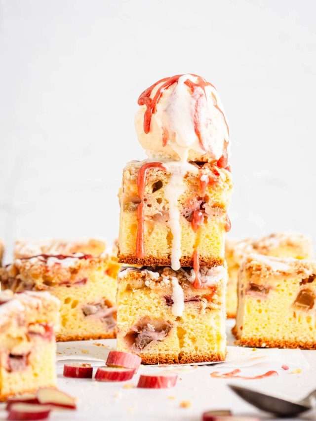 front view of rhubarb cake, slices stacked up, scoop of ice cream