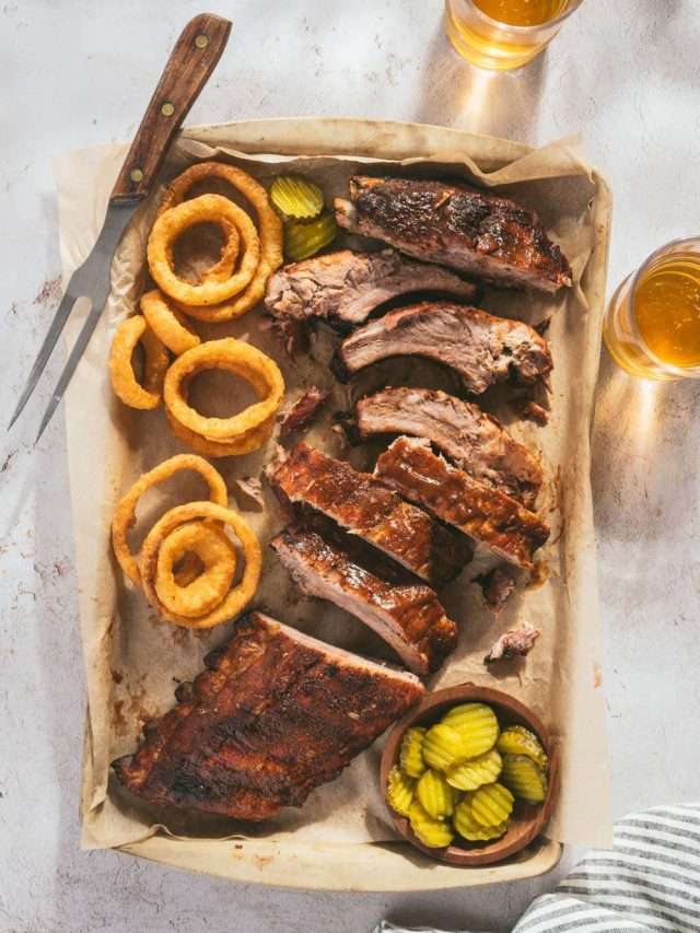 smoked ribs, cut into pieces, glass with beer, pickles