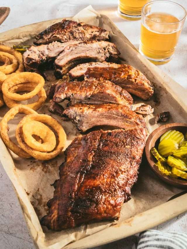 smoked ribs, cut into pieces, glass with beer, pickles