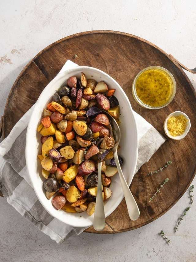 roasted veggies on a serving platter, dish with vinaigrette and other with lemon zest