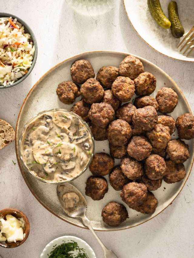 Meatballs on a serving platter; small side dishes around